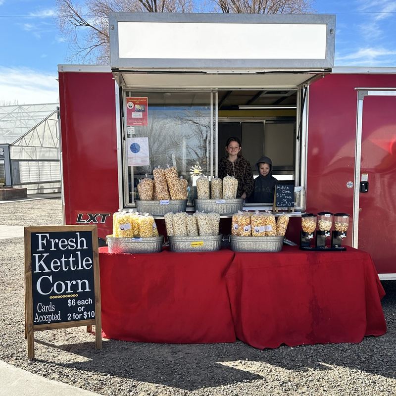Selling fresh kettle corn from the trailer at market